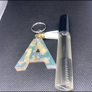 Lash and brow serum + a resin keychain.